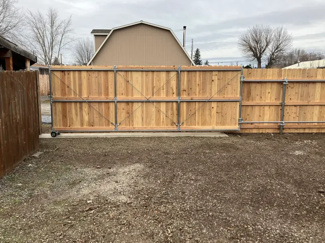 Large custom rolling wood gate with metal frame
